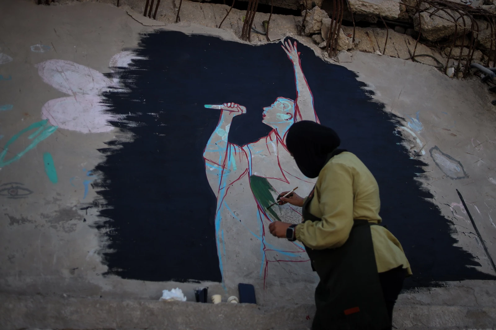 Anne Redwan, 26, ‌designed and painted the ‌mural with fellow artist Qusai Al-Helo. (Supplied)