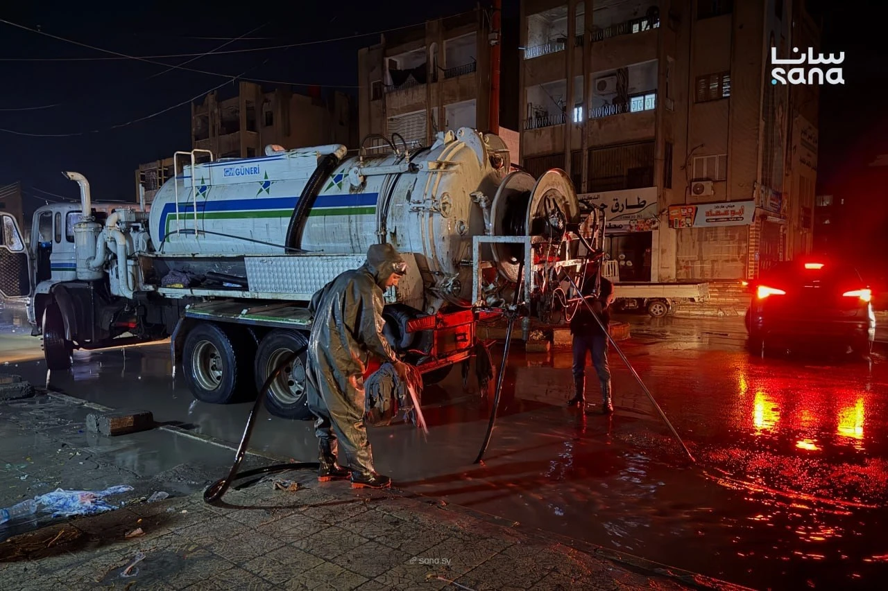 Syrian Civil Defense teams use a water-pumping truck to drain floodwater from a street following heavy rainfall in Syria, Oct. 28. (SANA)