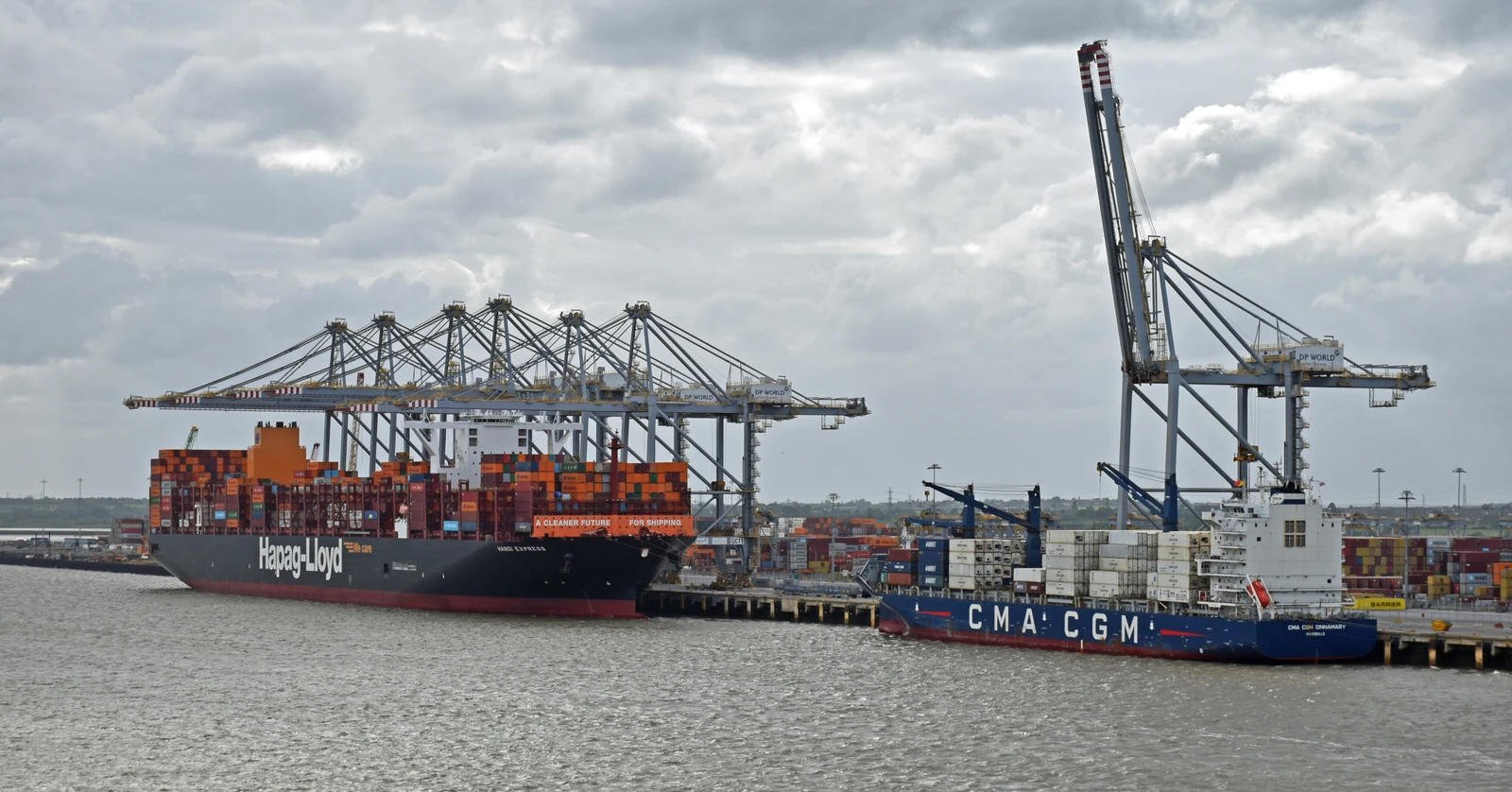 London Gateway Port, Essex, United Kingdom, May 19, 2026. Ships docked at container port on river Thames. Supply chain logistics and global trade. Overcast day outdoors. Elevated view.