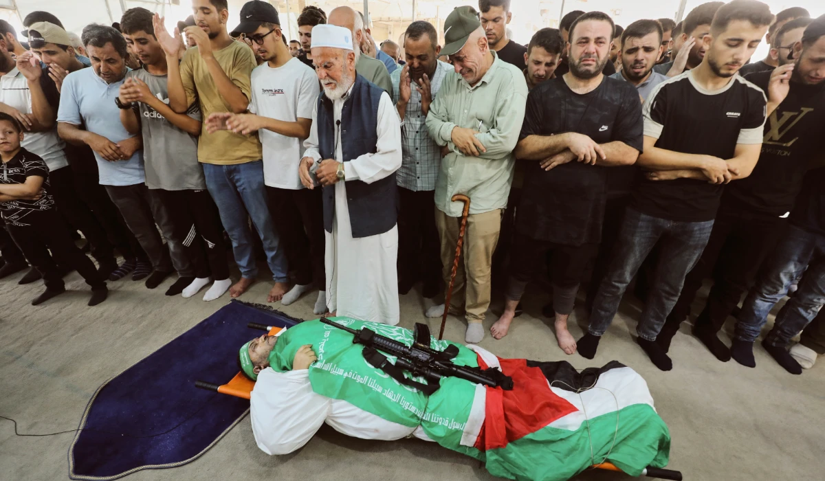 Palestinians mourn around the body of Ahmad Al-Batsh, a Qassam Brigades commander in Jabaliya, the military wing of Hamas, draped in a Hamas flag with a rifle placed on top, during his funeral after he was killed in an Israeli airstrike, in Gaza City, Tuesday, Sept. 15, 2026. (AP)