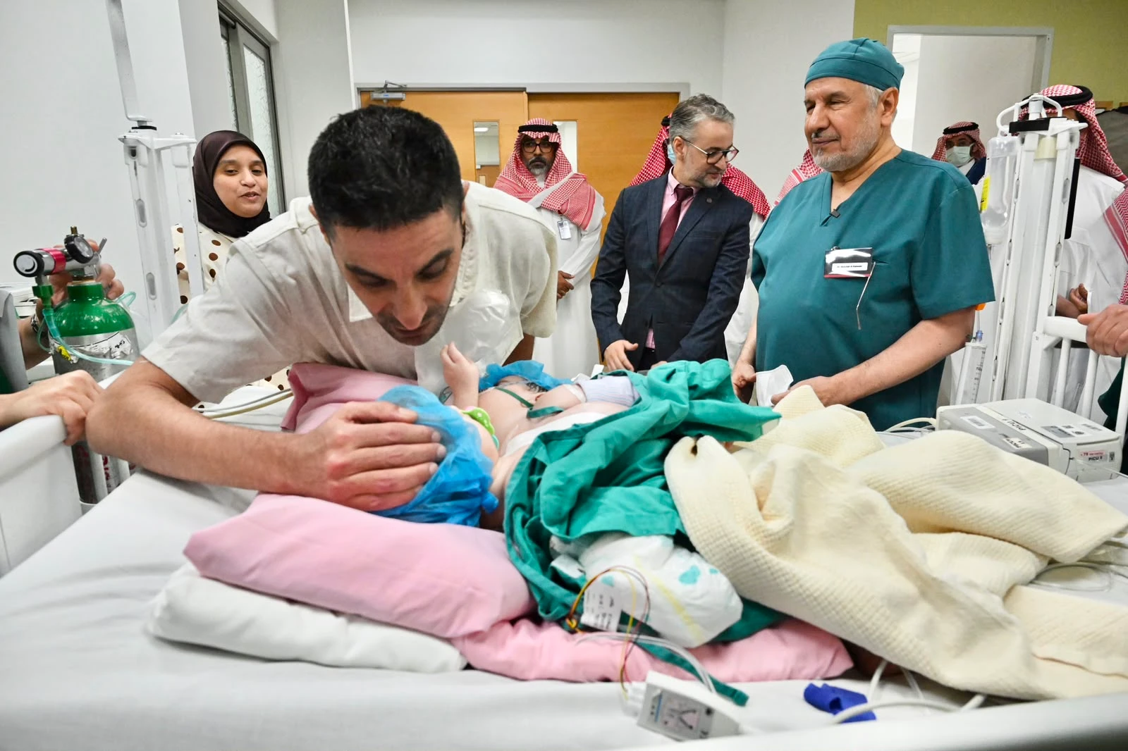 Separation surgery for Moroccan conjoined twins begins in Riyadh upon royal directives, Dr. Abdullah Al Rabeeah, head of the specialized medical team, seen with twins. (Supplied)