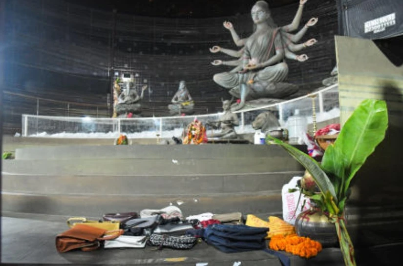 Purses and other belongings left behind by devotees lie on the floor of a worship venue for the Hindu festival of Durga Puja following a stampede, in Kolkata, Oct. 17, 2026. (AP)