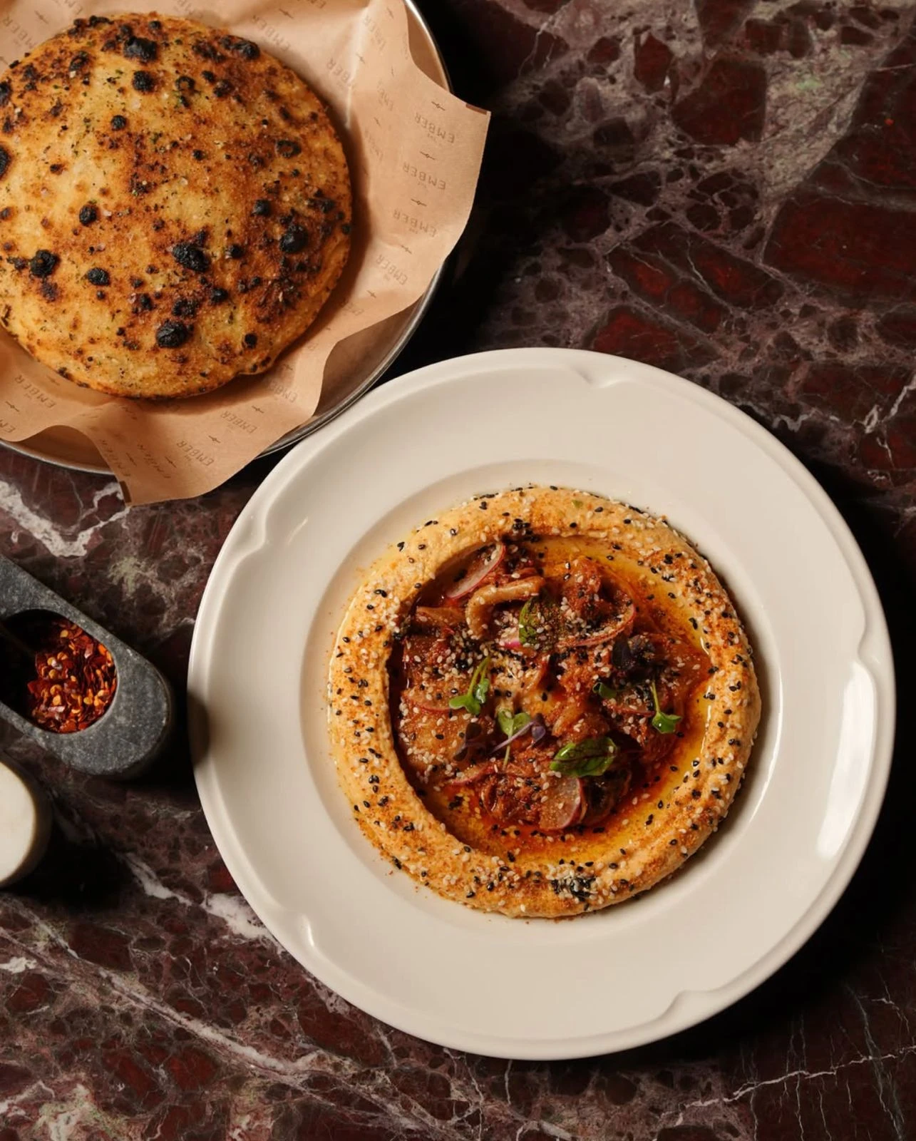 The kimchi hummus is worth trying with the freshly baked garlic bread. (Supplied)