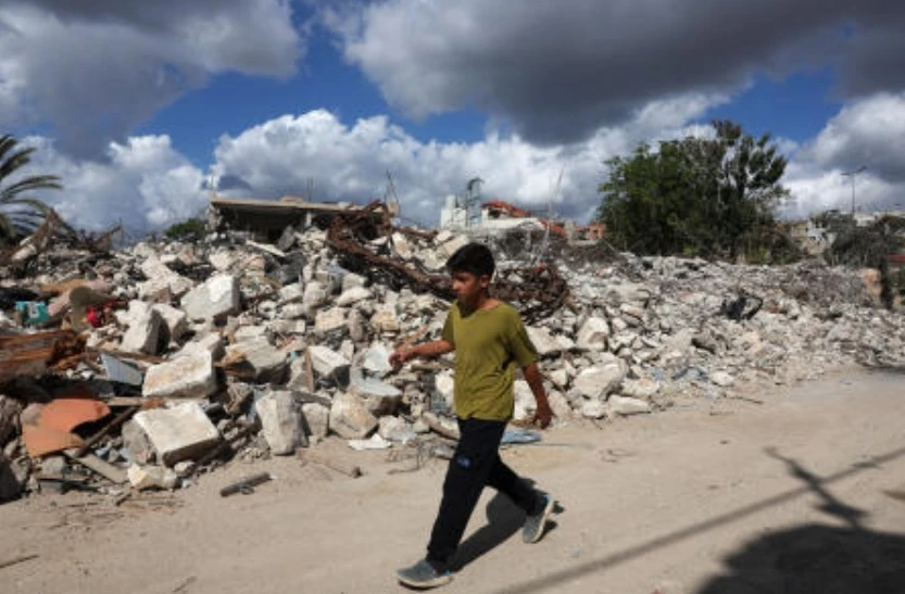 A child walks next to damaged homes in West Zawtar, southern Lebanon, Oct. 1, 2026. (Reuters)