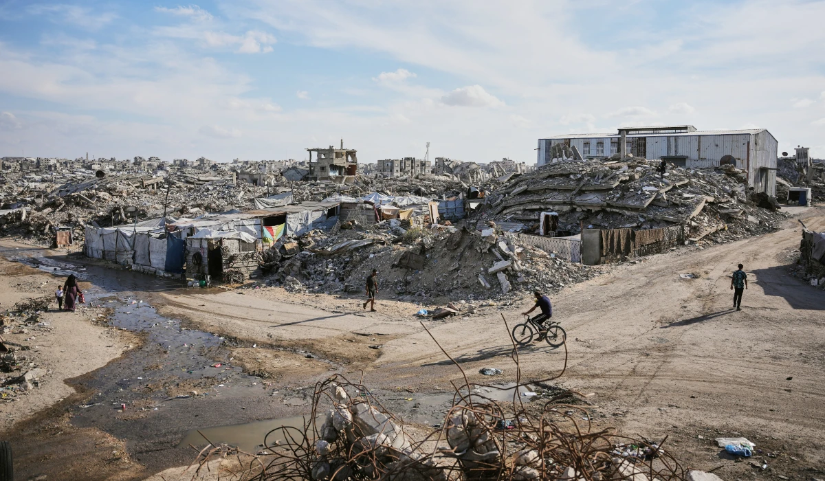 Palestinians walk along a street surrounded by buildings destroyed in Israeli military strikes during the Israel-Hamas war in Gaza City, Tuesday, Oct. 6, 2026. (AP)