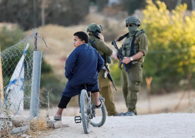Above, Israeli army soldiers in Umm Al-Khair in the Israeli-occupied West Bank on July 28, 2026. British activist Finn Joughin was in Umm Al-Khair doing protective presence when armed settlers then took him by force to a nearby settlement. (Reuters file photo)