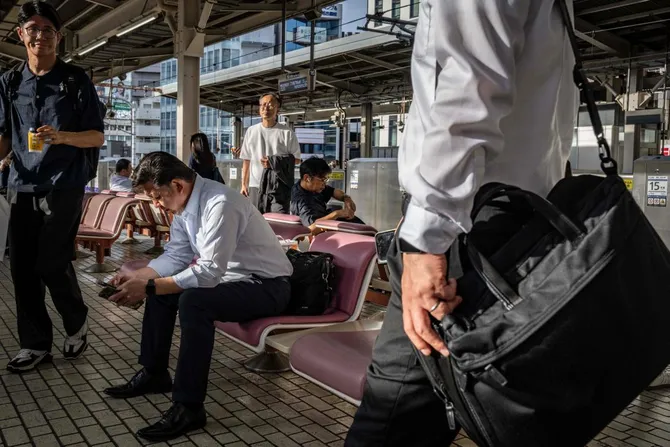 Japan train hits station workers, killing four
