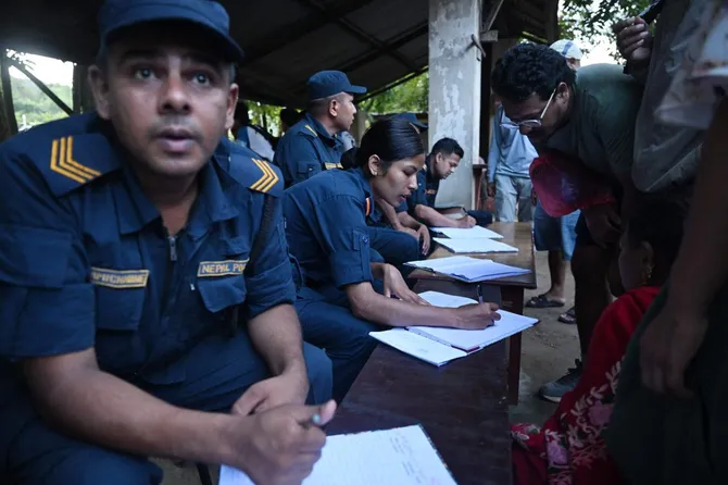 Above, Nepal police collect details of missing people from relatives as they wait at Trishuli army camp, in Nepal’s Nuwakot district on Aug. 28, 2026. More than 1,400 people missing after a deadly deluge and landslides swept away entire villages along their remote Himalayan border. (AFP)