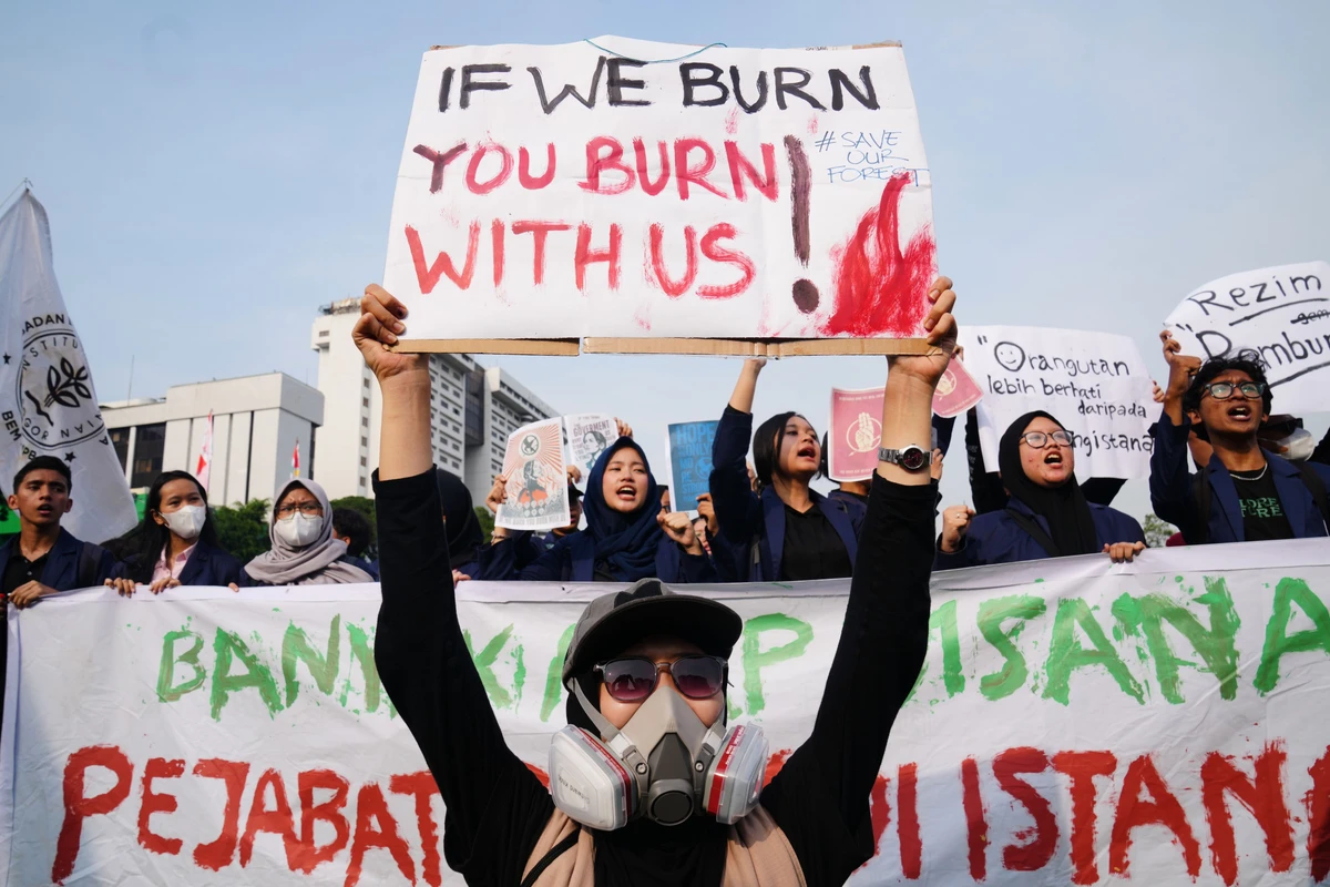 Protesters hold up posters demanding government action during a rally marking the second year since Indonesian President Prabowo Subianto took office in Jakarta, Indonesia, Tuesday, Oct. 20, 2026. (AP Photo/Tatan Syuflana)
