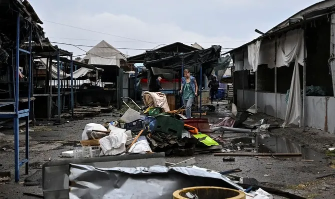 A resident walks at the site of a street market hit by a Russian drone, Zaporizhzhia, Ukraine, Aug. 19, 2026. (Reuters)