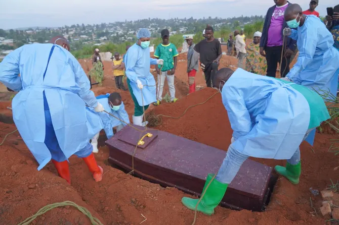 People dressed in protective gear lower into a grave the coffin containing the remains of six-year-old Baudjo Baraka Jules, who died of Ebola, in Bunia, Ituri province, eastern Congo on Aug. 18, 2026. (AP)