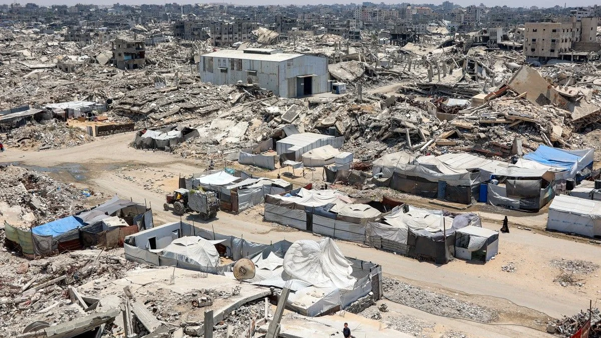 Tents and shelters are pictured next to rubble of collapsed buildings at a camp for people displaced by war in the Sheikh Radwan neighbourhood of Gaza City. (File/AFP) (AFP)
