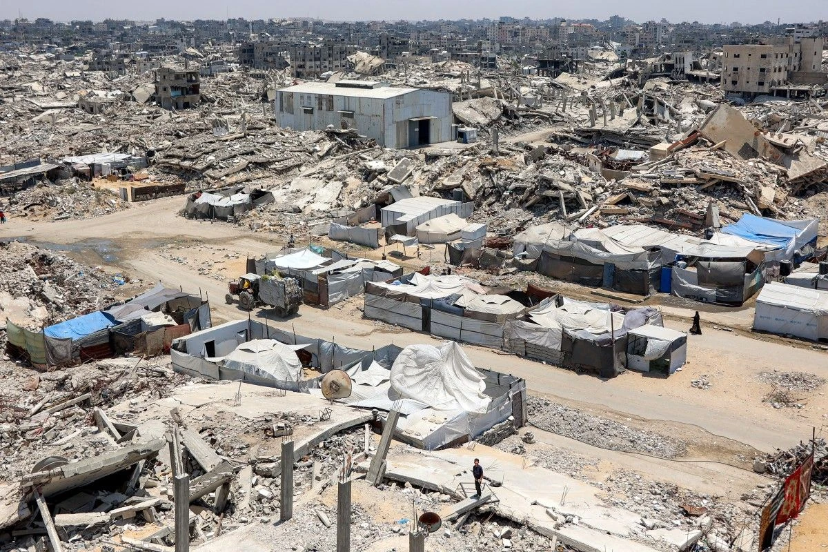 Tents and shelters are pictured next to rubble of collapsed buildings at a camp for people displaced by war in the Sheikh Radwan neighbourhood of Gaza City. (File/AFP)