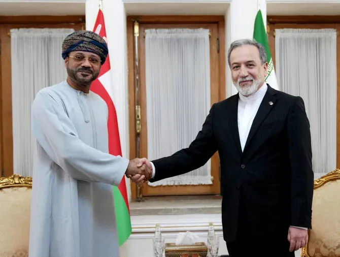 Iranian Foreign Minister Abbas Araghchi, right, with his Omani counterpart Sayyid Badr Al-Busaidi in Tehran on Aug. 25, 2026, as Tehran and Muscat seek a way to regulate the passage of ships through the Strait of Hormuz. (Iranian Foreign Ministry Office/AFP)