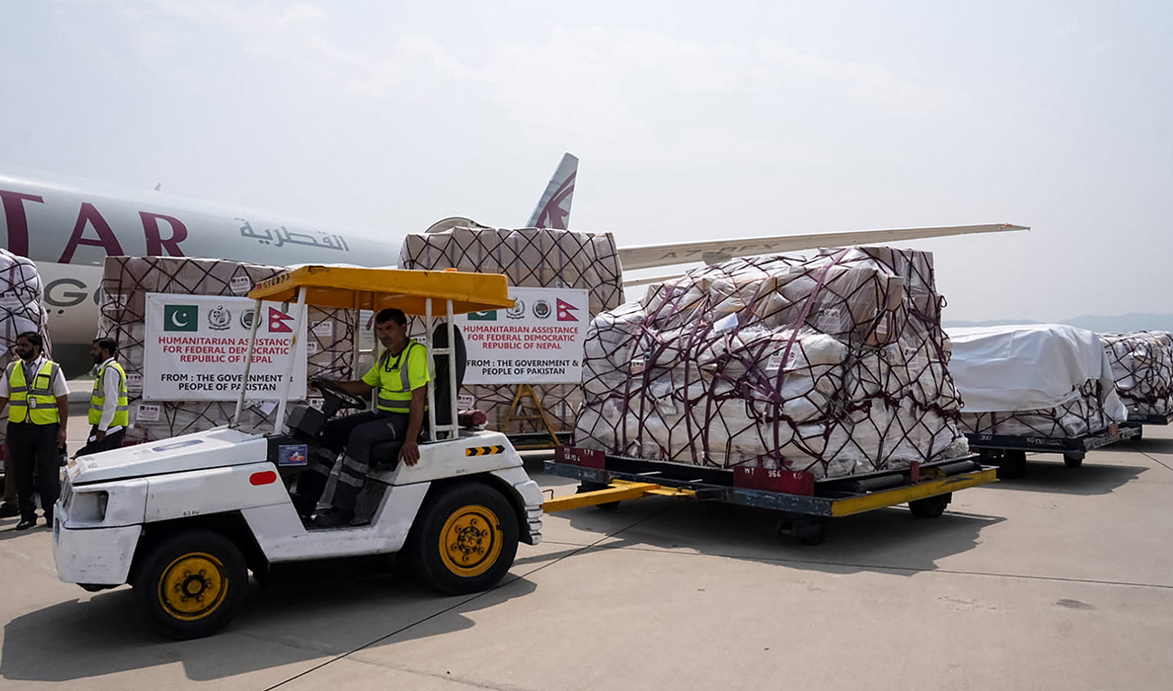 This handout photograph taken on September 6, 2026 and released by Pakistan’s National Disaster Management Authority (NDMA) shows workers loading humanitarian assistance from the Pakistan government for flood victims in Nepal before handing it over to Nepal's Ambassador to Pakistan Rita Dhital at Islamabad International Airport in Islamabad. (AFP)