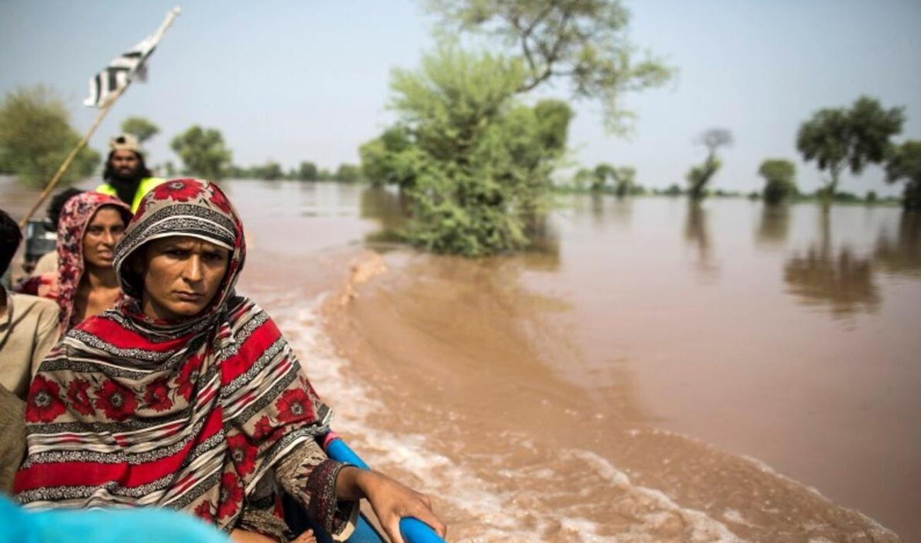 A flood victim sits on a boat while being evacuated from her flooded house following heavy rain in Jhang, Punjab province September 10, 2014. (Reuters/File)