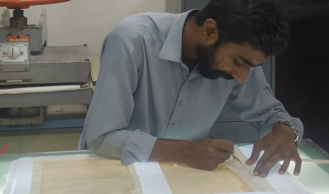Yousuf Jameel uses a tool to restore a document at the National Archives of Pakistan in Islamabad on September 28, 2026. (AN Photo)