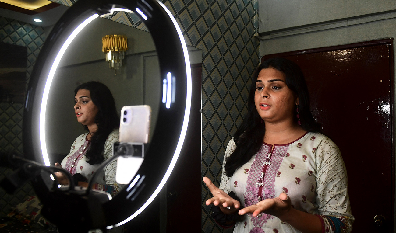 In this picture taken on September 20, 2023, a transgender rights activist and digital content creator Aradhya Khan records a video for the upcoming gender-rights protest 'Sindh Moorat March' in Karachi. (AFP./File)