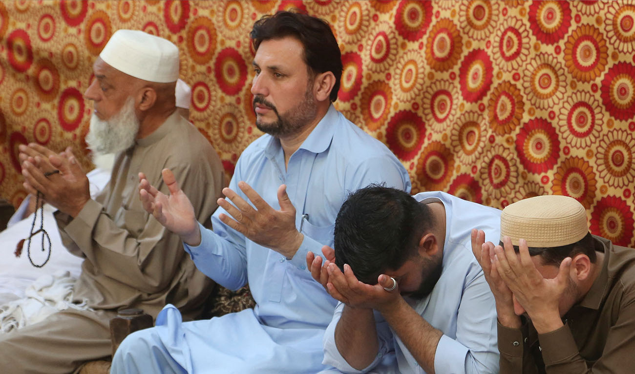 People mourn as they attend prayers for the victims of a school roof collapse in Peshawar, Pakistan, October 16, 2026. (Reuters)