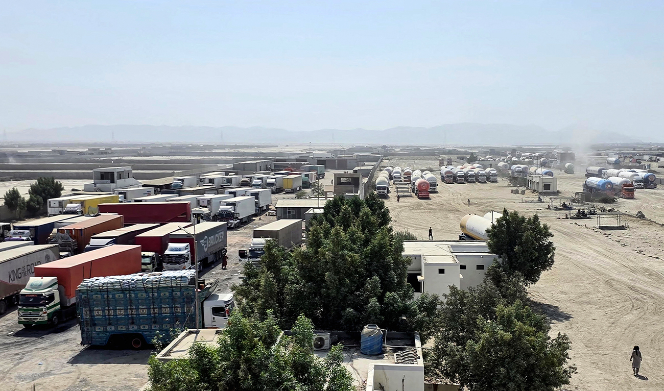 Cargo trucks remain halted at the Gabd-Rimdan border crossing in Pakistan's Balochistan province on October 21, 2026, following the temporary suspension of trade between Pakistan and Iran. (AFP