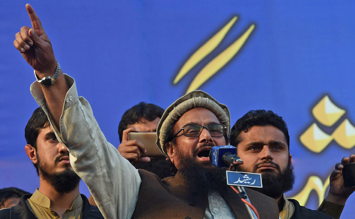 In this file photo, Pakistani head of the Jamaat-ud-Dawa (JuD) organization Hafiz Saeed, center, speaks to protesters as they gather in a rally to mark Kashmir Solidarity Day in Lahore on Feb. 5, 2018. (AFP)