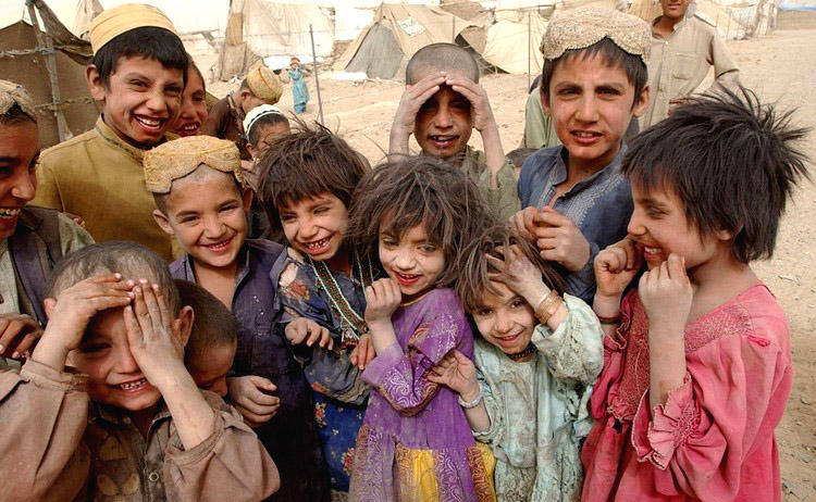 Unidentified Afghan children from the Kuchi nomadic tribe laugh despite horrible living conditions. (AFP)