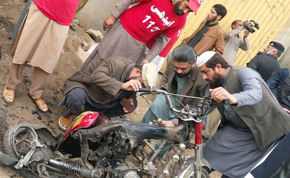 Security and rescue personnel inspect the bike used in the bomb attack in Peshawar on Friday. (AN Photo)