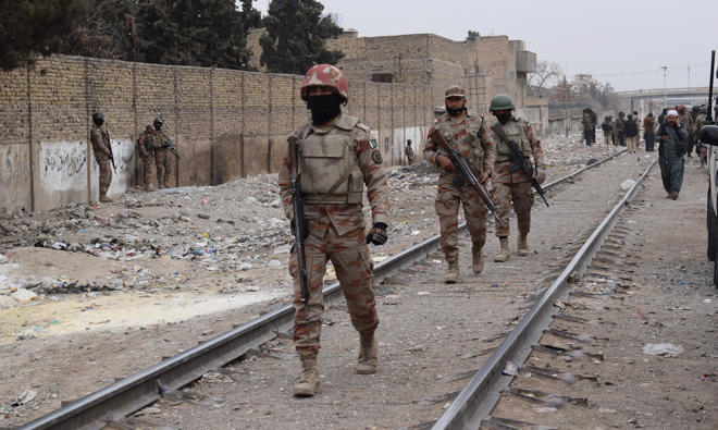 Pakistani paramilitary soldiers patrol near the site of an attack by gunmen on policemen in Quetta. (AFP)