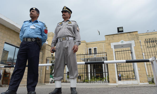In this file photo, Pakistani policemen stand in front of the Election Commission of Pakistan (ECP) office in Islamabad. (AFP)