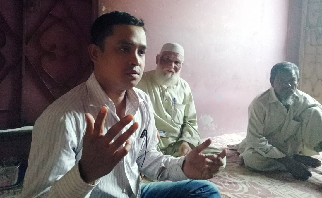 Syed Mohammad Yousuf, A Rohingya Youth and Activist talk to Arab News in Arakani Colony, Karachi. Mohammad Saleem also seen sitting in the Photo. (AN photo)