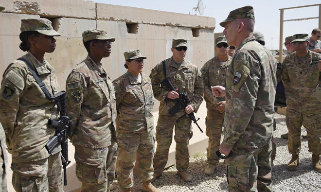 In this file photo, The US commander in Afghanistan John Nicholson (R) talks with soldiers ahead of a handover ceremony at Leatherneck camp in Lashkar Gah in the Afghan province of Helmand. (AFP)