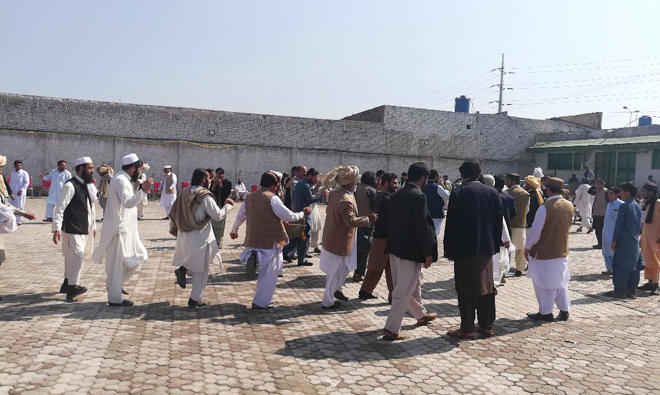 Tribal elders dance at FATA Jirga in Peshawar on Sunday.