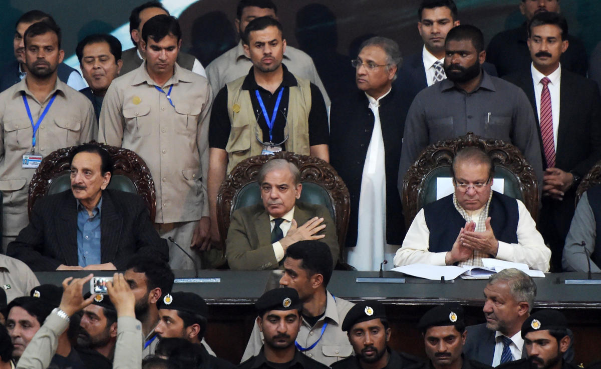 Pakistani ousted prime minister Nawaz Sharif, right, claps after his younger brother and Chief Minister of Punjab province Shahbaz Sharif, center, is elected as President of ruling Pakistan Muslim League-Nawaz (PML-N) party at the General Workers Council in Islamabad on March 13, 2018. (AFP)