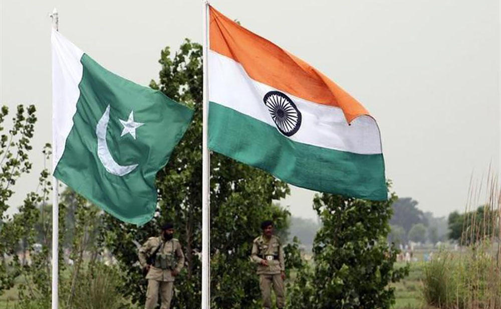 In this file photo, Pakistani rangers stand near the Indian, right, and Pakistani national flags during an annual fair near Pakistan border in Chamliyal, 45 km (28 miles) west of Jammu, June 26, 2008. (REUTERS)