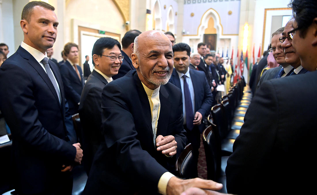 In this file photo, Afghan President Ashraf Ghani shakes hands with a foreign delegate at the second Kabul Process conference at the Presidential Palace in Kabul on Feb. 28, 2018. (AFP)