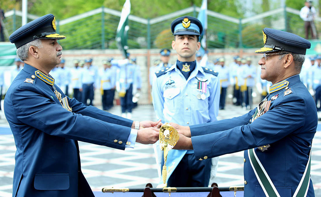 Outgoing Sohail Aman handing over the Command Sword to his successor Mujahid Anwar Khan during a change-of-command ceremony in Islamabad on Monday. (Photo courtesy: Pakistan Air Force (PAF)