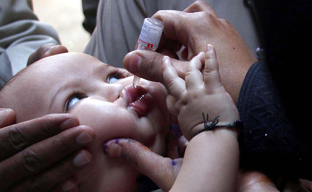 In this file photo, an anti-polio campaigner administrates vaccine to an infant in Karachi on Aug. 29, 2016. (Shutterstock)