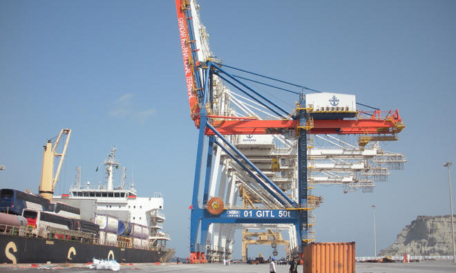 In this file photo, a Pakistani naval personnel stands guard near a ship carrying containers at Gwadar Port. (AFP)