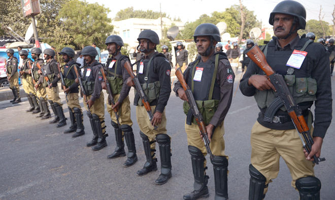 In this file photo, Pakistani policemen stand guard during a Shiite Muslim religious procession in Karachi. (AFP)