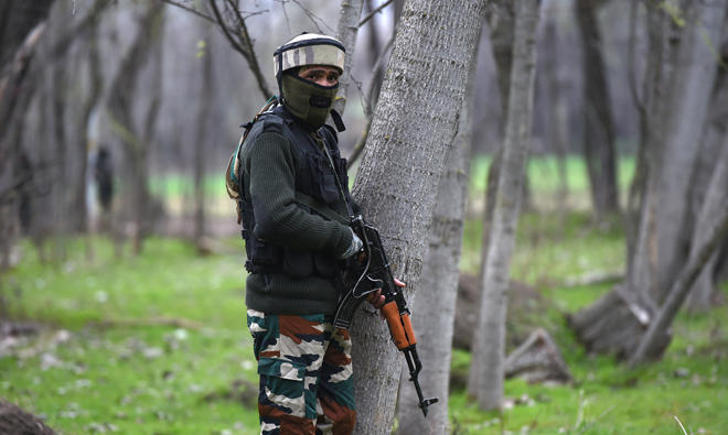 In this file photo, Indian army soldiers takes a position near a gunbattle between suspected militants and government forces at Balhama area of Khanmoh on the outskirts of Srinagar on Mar. 15, 2018. (AFP)