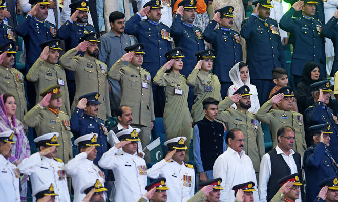 In this file photo, Pakistani armed forces officials salute as they listen the national anthem after hoisting the national flag during a ceremony to mark the country's Independence Day in Islamabad on Aug.t 14, 2017. (AFP)