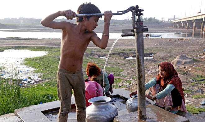 A Pakistani boy fetches clean water on World Water Day, outside Lahore city in Pakistan on Mar. 22, 2018. (AP)