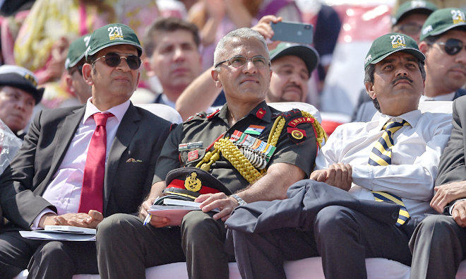 An Indian delegation including Indian Army officer Sanjay Vishwasrao, center, watch the Pakistan Day military parade in Islamabad on March 23, 2018. (AFP)