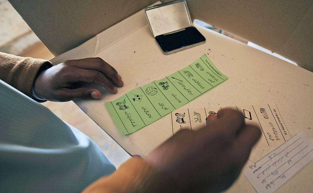 In this file photo, a Pakistani man stamps his ballot papers as he cast his vote at a polling station in Chakri, some 40 km from Islamabad, on Feb. 18, 2008. (AFP)
