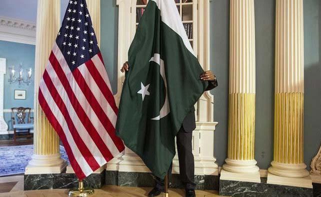 In this file photo, a State Department contractor adjusts the Pakistan national flag before a meeting between the then US Secretary of State John Kerry and Pakistan’s former Interior Minister Chaudhry Nisar Ali Khan on the sidelines of the White House Summit on Countering Violent Extremism at the State Department in Washington Feb. 19, 2015. (REUTERS)
