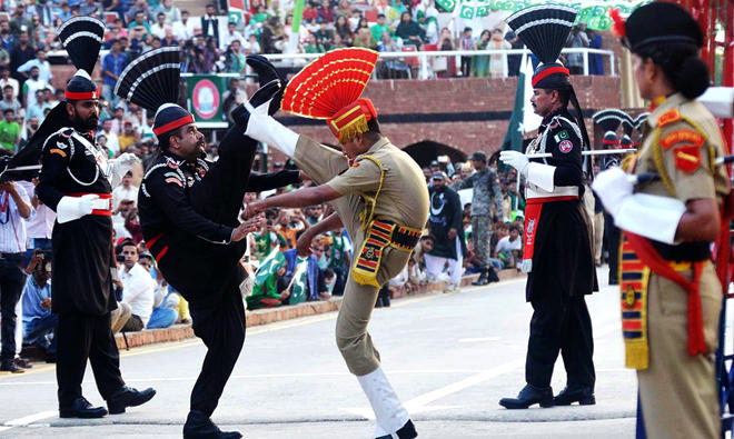 In this file photo, Pakistani Rangers and Indian Border Security Force personnel perform during the daily beating of the retreat ceremony at the India-Pakistan Wagah Border Post. (AFP)