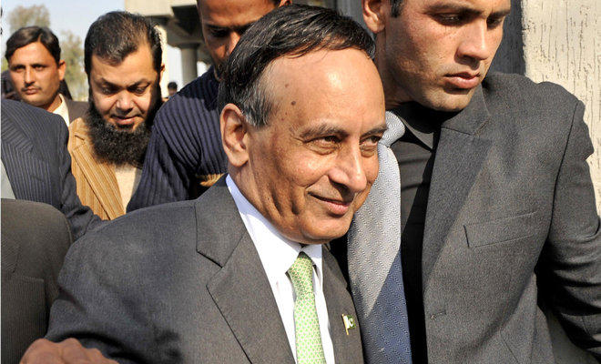 In this file photo, Pakistan’s former ambassador to United States Husain Haqqani, center, walks with officials as he leaves The High Court Building in Islamabad on Jan. 9, 2012. (AFP)