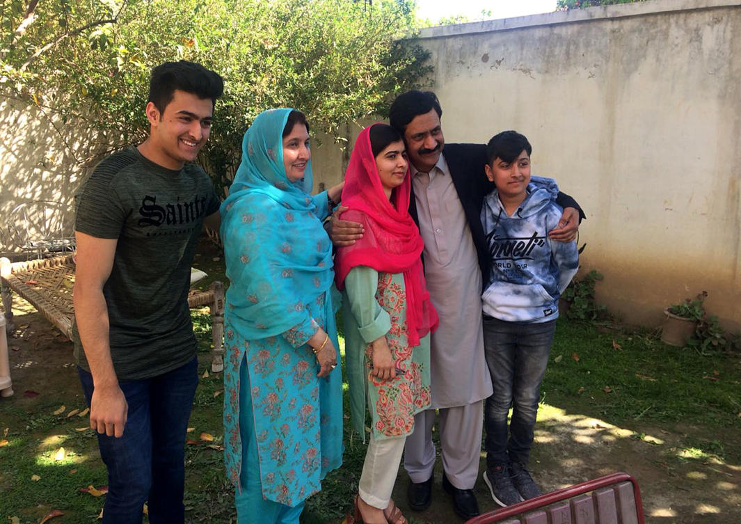 Pakistan’s Nobel Peace Prize winner Malala Yousafzai, center, poses for a photograph with her family members at her native home during a visit to Mingora, the main town of Pakistan Swat Valley, Saturday, March 31, 2018. (AP)