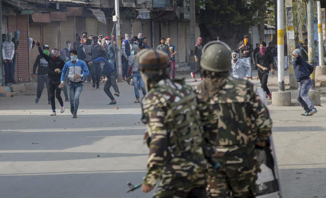 Kashmiri protesters throw stones and bricks at Indian paramilitary soldiers on the outskirts of Srinagar, Indian controlled Kashmir on April 3, 2018. (AP)