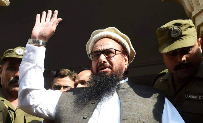 In this file photo, Pakistan head of the Jamaat-ud-Dawa (JuD) organization Hafiz Saeed waves to supporters in Lahore. (AFP)
